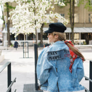Portrait of stylish woman wearing jeans jacket and black cap