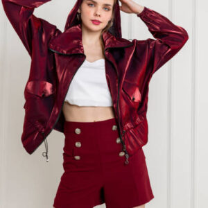 Blonde young woman wearing bright cherry jacket and short shorts. high heels.